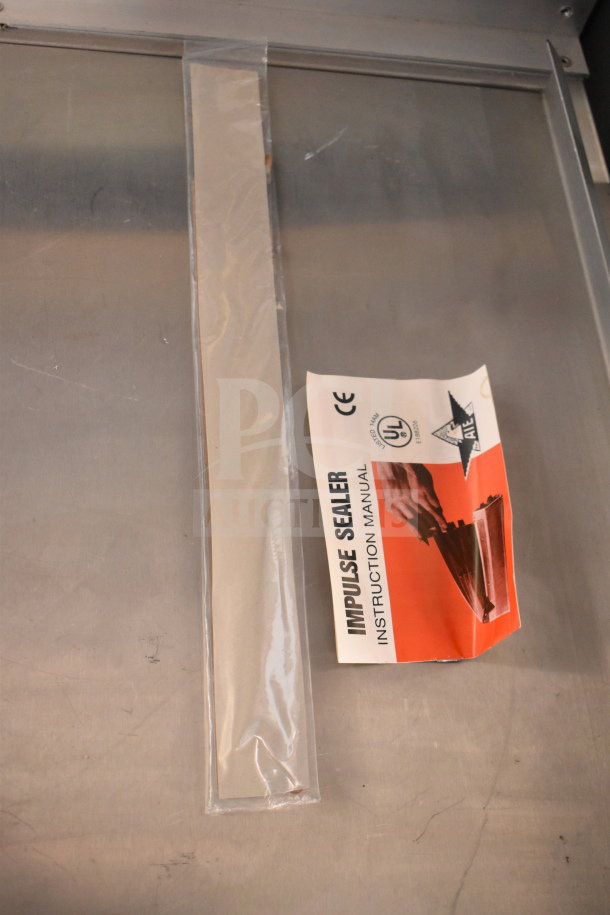 American International Electric AIE-305 Impulse Sealer, 220 Volts, shown with instruction manual.