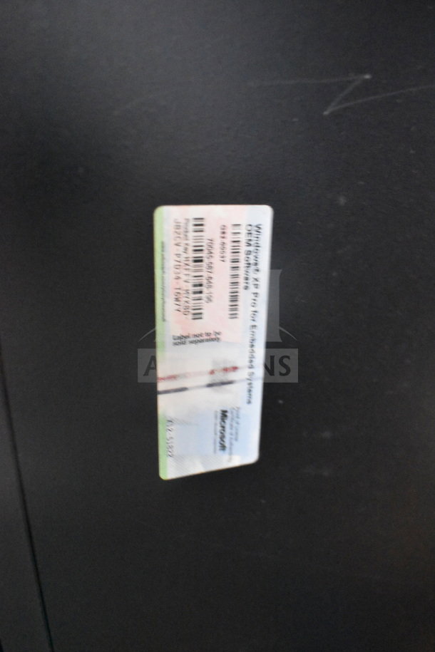 Close-up of a Windows XP Pro label on a computer tower. The label indicates the operating system installed.