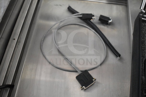 Radon Measurement System with cables and connectors; includes Radon WL Meter and Radon Data Recorder; on metal surface.