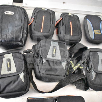 Nine camera bags with two cameras including Nikon Coolpix and Garmin Nuvi. Various sizes, mostly black with brand logos.