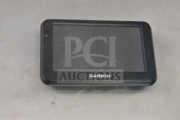 Garmin GPS device with black casing, touchscreen display, "Garmin" logo at the bottom, surface wear visible.