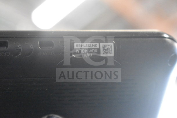 Upside-down view of a Garmin GPS device, showing model number nuvi 40LM and serial 2HJ371480, in used condition.