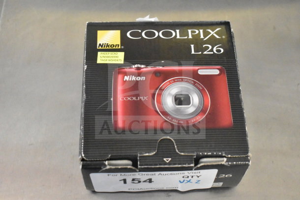 Nikon Coolpix L26 digital camera in original box, new condition. Visible labels show model and product codes.