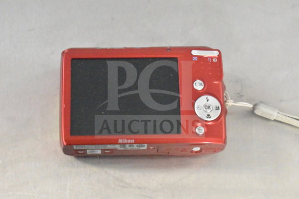 Nikon Coolpix L26 digital camera in red, in original box, with screen and control buttons visible, excellent condition.