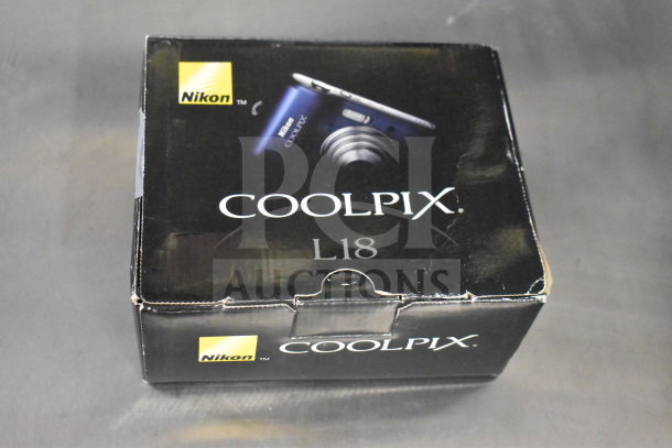 Nikon Coolpix L18 digital camera in original box, visible branding. Includes models L18 and L26.