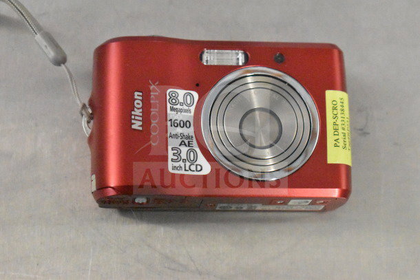 Red Nikon Coolpix L18 camera, 8MP, 3.0" LCD, anti-shake, original box, PA DEP-SCRO sticker, serial 833845.