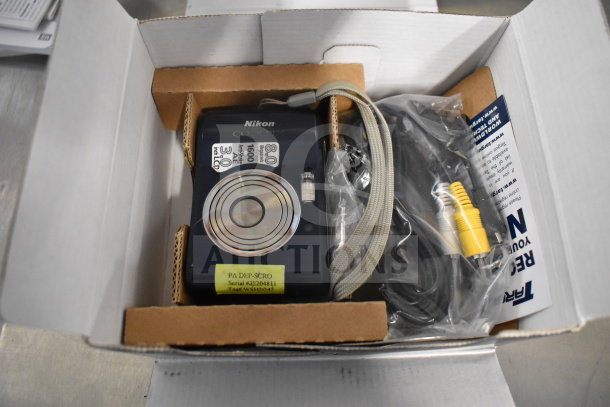 Nikon Coolpix L18 digital camera in original box with cables; 8.0 MP, 3.0" LCD, new condition, labeled with serial #3220481.