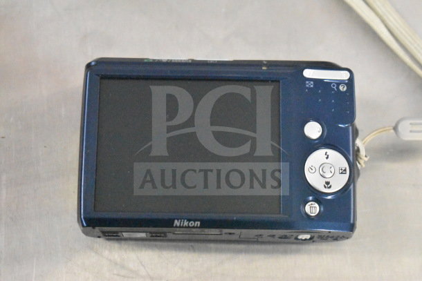 Nikon Coolpix digital camera model L18, shown in original condition with a blue body, displayed on a surface.