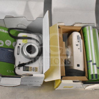 Two Coolpix S32 digital cameras in original boxes, showing labels and accessories. Cameras appear in excellent condition.
