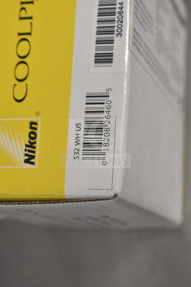 Nikon Coolpix S32 digital cameras, new in original packaging. Box shows model number and barcode.