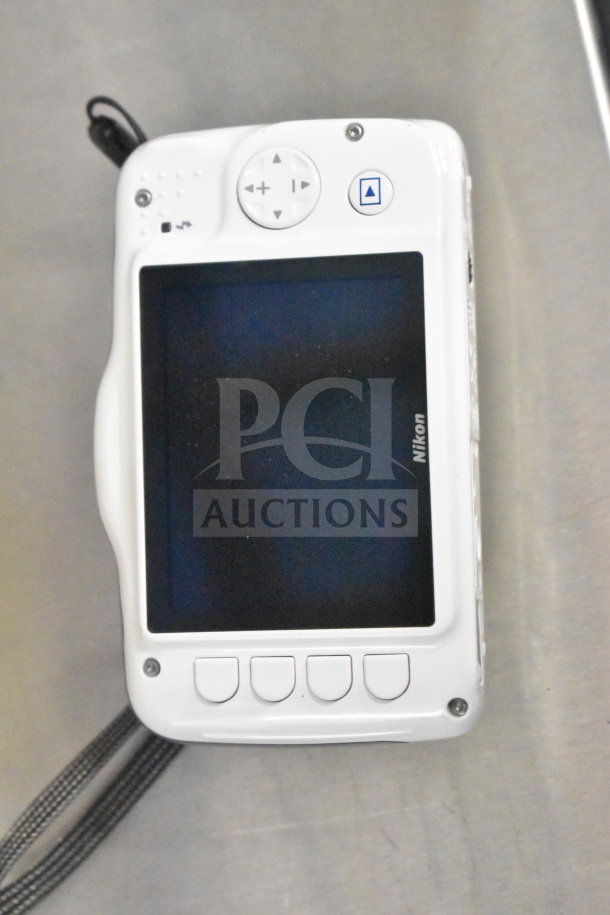 Nikon Coolpix S32 digital camera, white, back view with screen and control buttons visible, original box included.