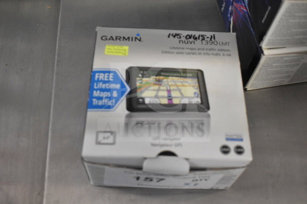 Garmin GPS Nuvi 1390 in original box, includes lifetime maps and traffic. Box shows product image and features.