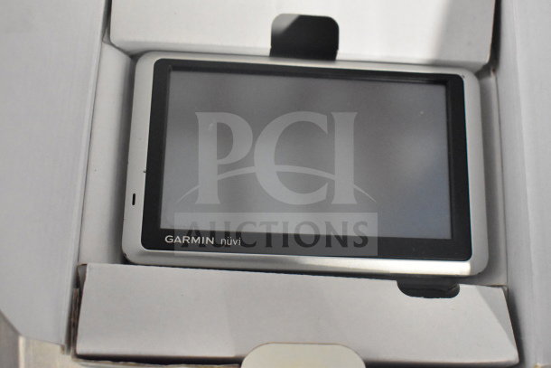 Garmin Nuvi GPS in original box, model visible, screen and casing intact, includes Nuvi 55, 40, 1350 models.