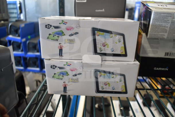 2 Carrvax X002D2WGVF GPS units in original boxes, featuring map displays, pristine condition.