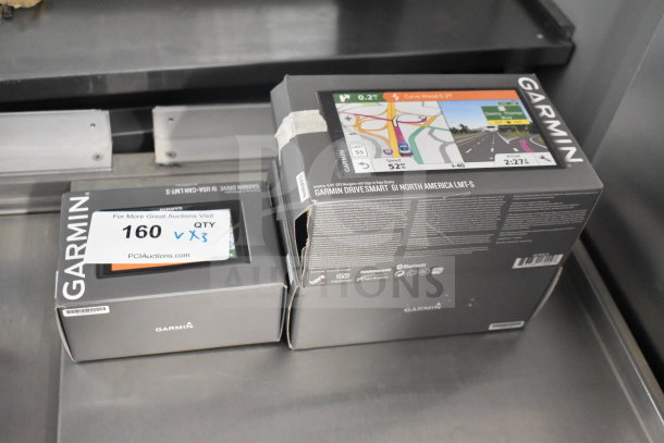 Three Garmin DriveSmart 61 North America LMT-S GPS units in original boxes, labeled "QTY X3".