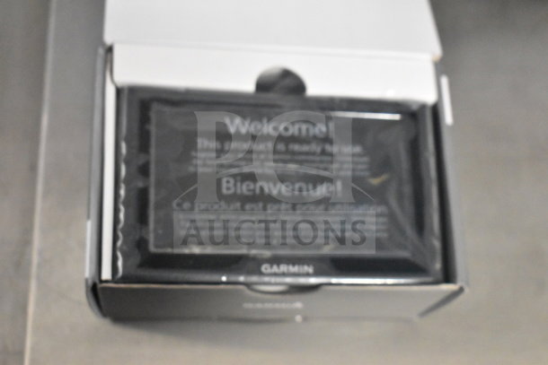 Garmin GPS units in original packaging, brand new, unopened. Box includes welcome instructions visible.