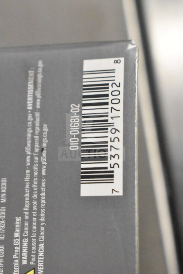 Three Garmin GPS units in original box, barcode visible. New condition, potential valuable auction item.