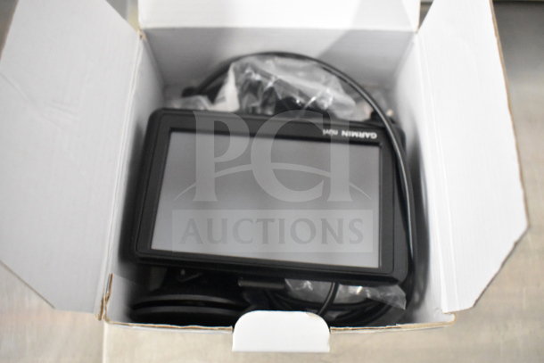 Garmin GPS devices in original box, including eTrex Legend H, eTrex 20, Nuvi 1390LMT; new condition.
