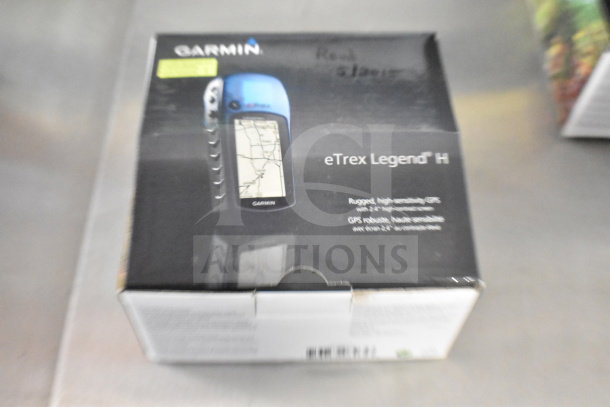 Garmin GPS set in original box, includes eTrex Legend H, eTrex 20, Nuvi 1390LMT. Box shows product features and branding.