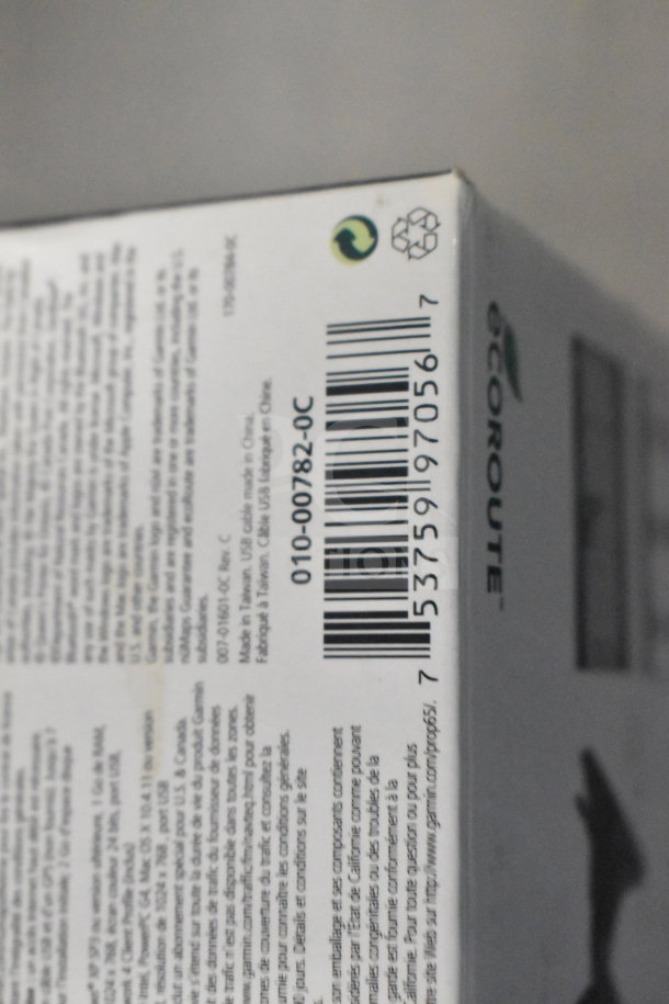 Original box containing Garmin GPS devices: eTrex Legend H, eTrex 20, and Nuvi 1390LMT. Barcode and eco labels visible.