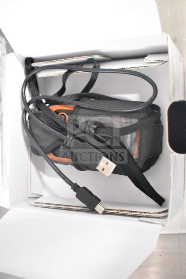 Garmin GPS units in original box, includes eTrex Legend H, eTrex 20, and Nuvi 1390LMT, USB cable included.