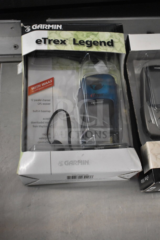 Garmin eTrex Legend GPS in original packaging, featuring WAAS, 12-channel receiver, built-in basemap. Box slightly worn.
