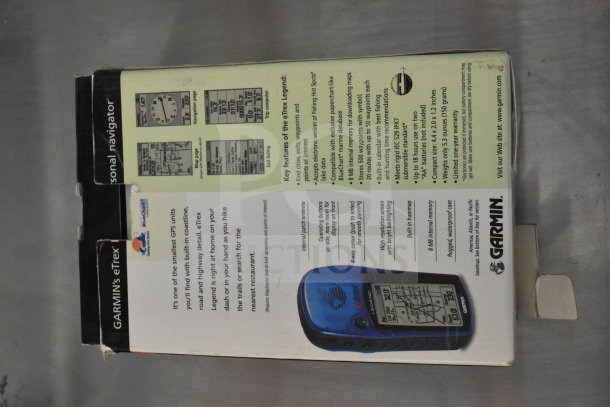 Garmin GPS units in original box, including Marine Navigator 76 and eTrex Legend, key features listed on packaging.