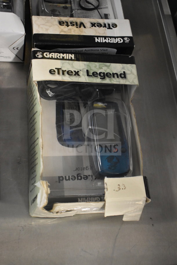 Garmin GPS set including eTrex Legend in original box, slightly worn packaging. Includes four units, model 76 Marine Navigator.