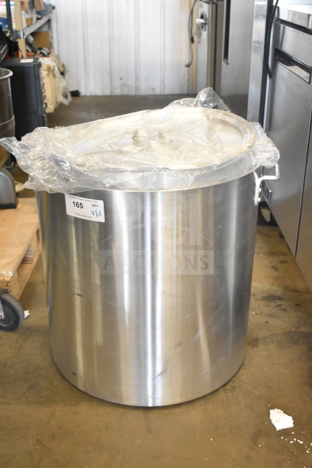 Brand new Choice Heavy Weight Aluminum Stock Pot, 160 Qt., with protective wrapping, labeled for auction, slight scratches visible.