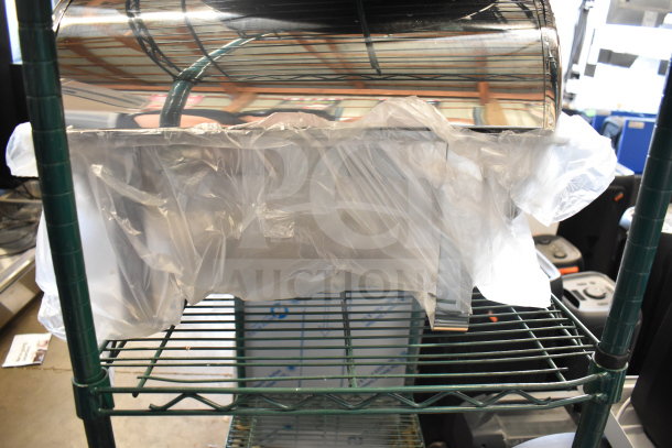 Brand new 407RTCHROM Choice Deluxe 8 Qt. Full Size Chrome Accent Roll Top Chafer wrapped in plastic on storage shelf.