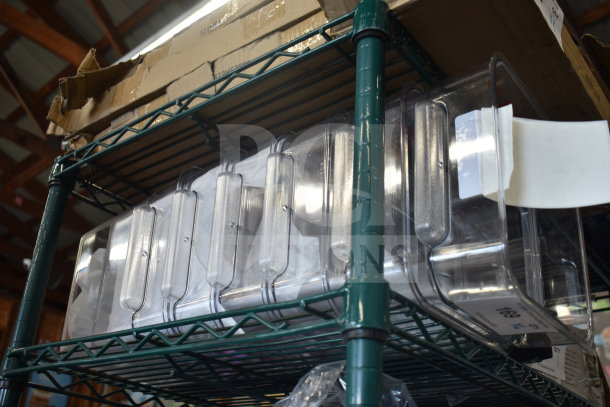 6 Vigor 247S8CL 8 Qt. clear polycarbonate storage containers on a shelf, new with minor scratches.