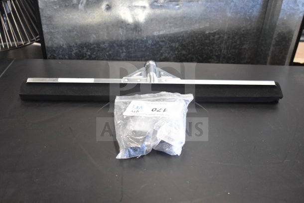 Brand new Carlisle Flo-Pac 22" black double foam floor squeegee with metal frame and Narvon evaporator coil in packaging.