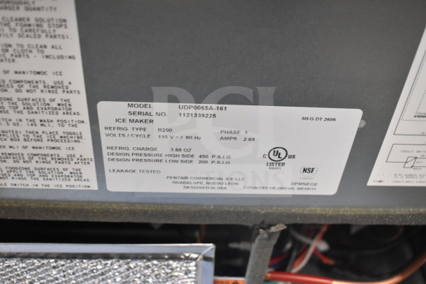 Label on Manitowoc UDP0065A-161 ice machine shows model info, voltage (115V), phase (1), amps (2.65), refrigerant type (R290).