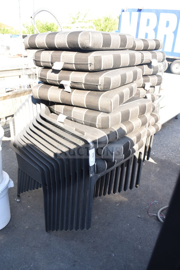 Stack of 17 black patio arm chairs with gray and black striped cushions, in good condition, labeled "17x."