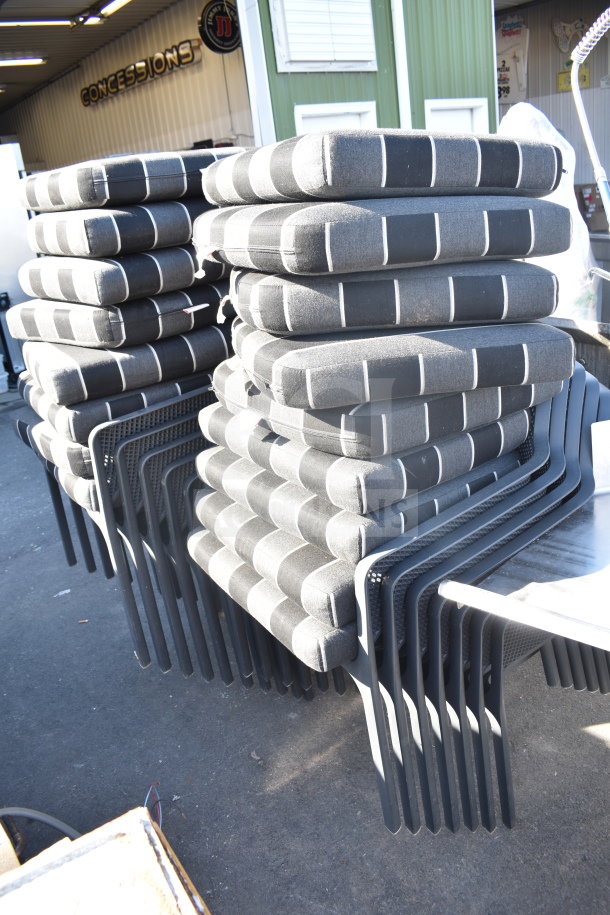 17 black patio arm chairs with gray and black cushions, stacked; durable, modern design, ideal for outdoor use.