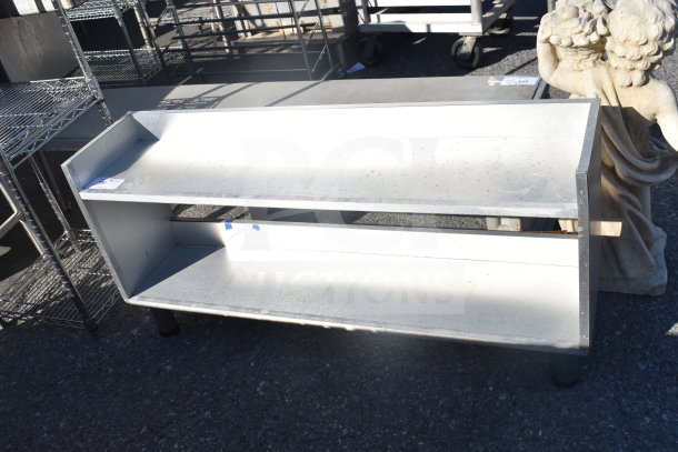 Commercial 2 Tier Shelf in metal, featuring durable construction. Shows signs of wear. Ideal for storage or display.