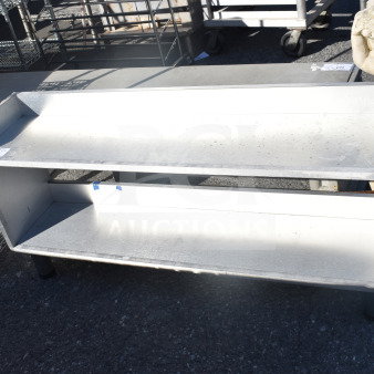 Commercial 2 Tier Shelf in metal, featuring durable construction. Shows signs of wear. Ideal for storage or display.