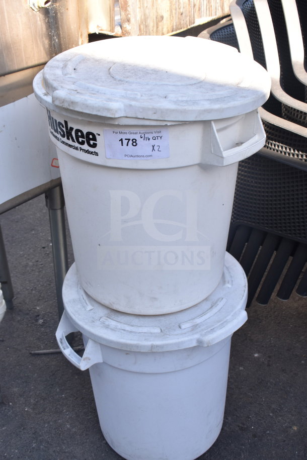 Two white Huskee poly trash cans with lids, showing signs of wear; labeled "178, Qty X2" for auction.