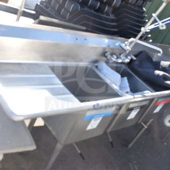 Commercial 3 bay sink with dual drain boards, stainless steel, includes faucet, pre-owned condition, visible labels on basins.