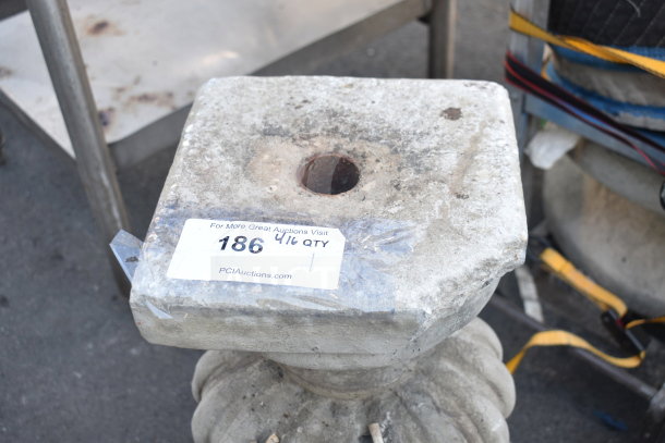 Stone planter with weathered patina, square top, and central drainage hole. Auction label reads "186, 4/16 QTY".
