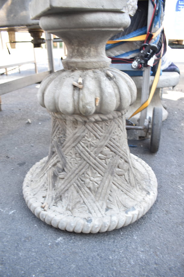 Ornate stone planter with intricate lattice and floral design, showing weathered condition. Ideal for garden decor.