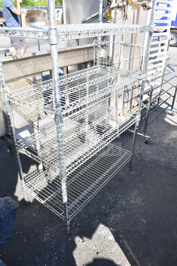 Chrome finish 6 tier wire shelving unit, outdoor setting, good condition, buyer must dismantle, freight charges apply.