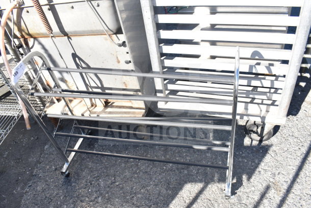 Metal shoe rack with four tiers, sturdy construction, slightly worn. Auction tag reads "189" on the side.