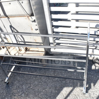 Metal shoe rack with four tiers, sturdy construction, slightly worn. Auction tag reads "189" on the side.