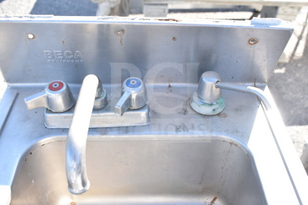 Stainless steel single bay sink by Beca Equipment, features dual taps, moderate wear and surface rust.