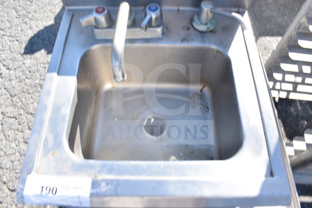 Stainless steel single bay sink with dual faucet knobs; visible wear and rust spots; labeled "190".