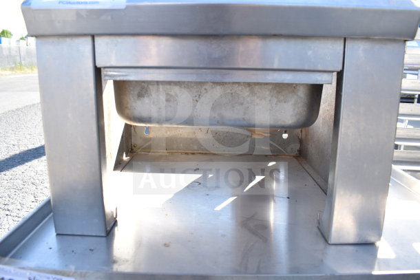 Stainless steel single bay sink, used condition with visible wear. No visible branding or markings. Suitable for commercial use.