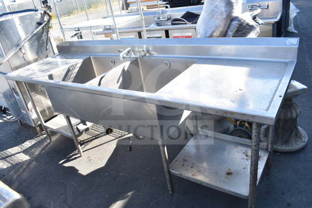 Commercial 2 bay stainless steel sink with dual drain boards, used condition, ideal for restaurant kitchens.