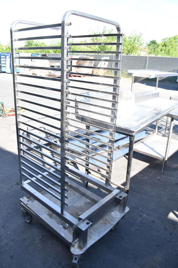 Commercial pan transport rack on casters for roll-in oven, metal frame, multi-level, outdoor condition.