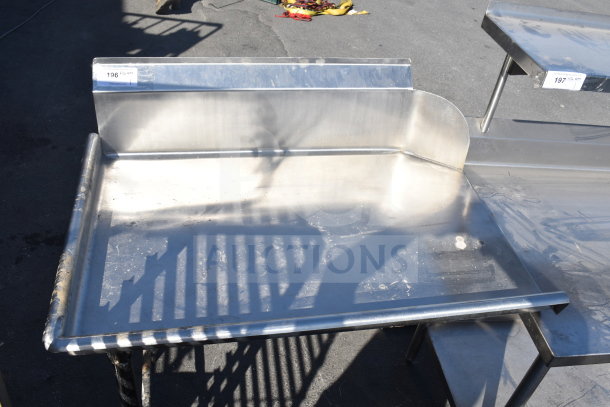 Commercial dishwasher table, left side clean side, stainless steel, used condition, visible paint marks, features a backsplash.